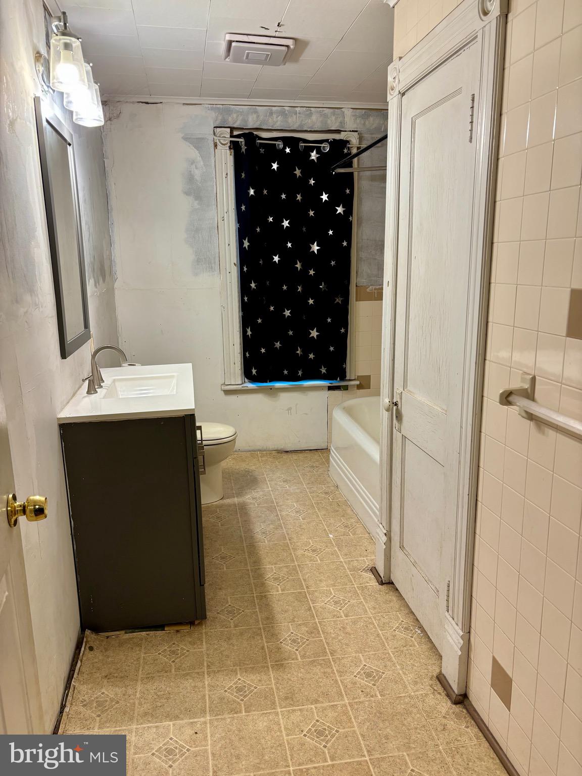 1006 Main Street Saxton, PA 16678 - Photo 29 of 40 a bathroom with a sink a toilet and shower