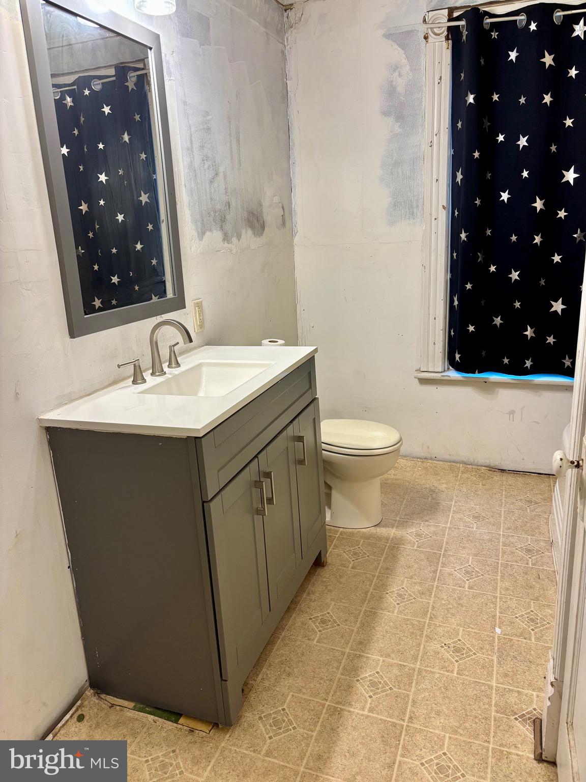 1006 Main Street Saxton, PA 16678 - Photo 30 of 40 a bathroom with a sink toilet and vanity