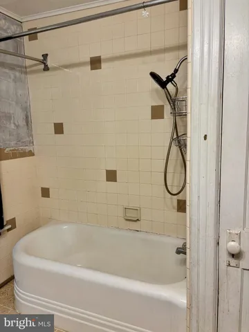 a bathroom with a bath tub with a shower