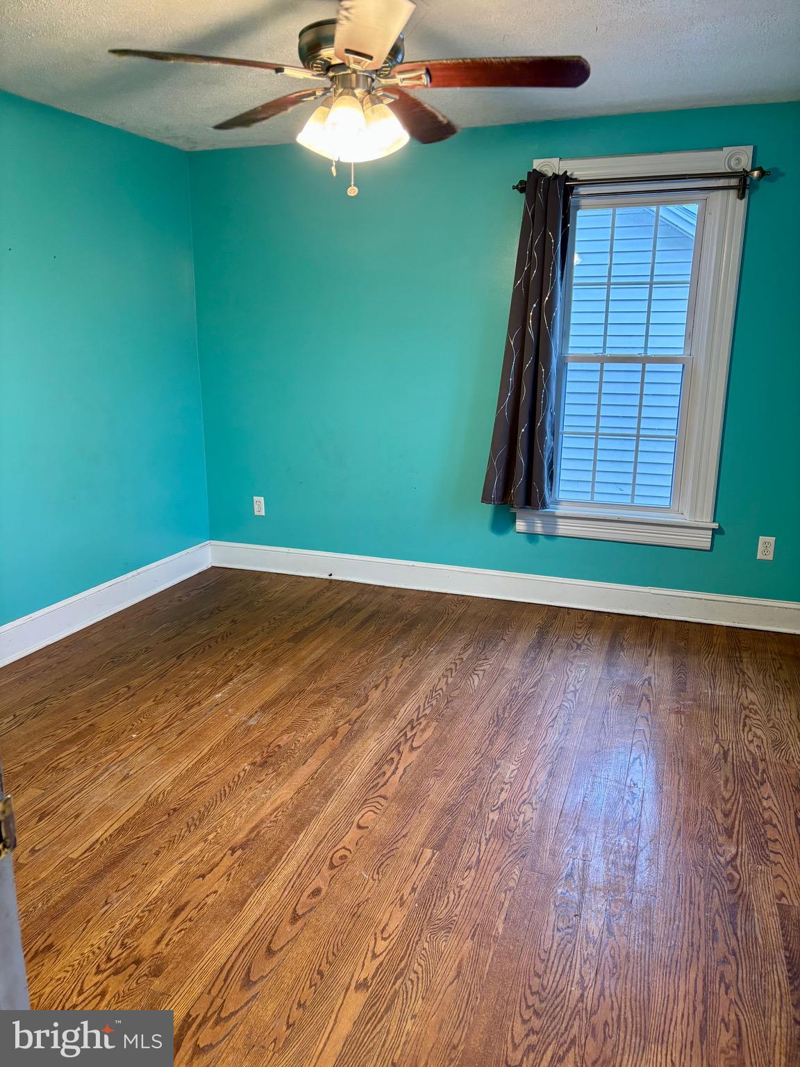 1006 Main Street Saxton, PA 16678 - Photo 32 of 40 an empty room with wooden floor fan and window