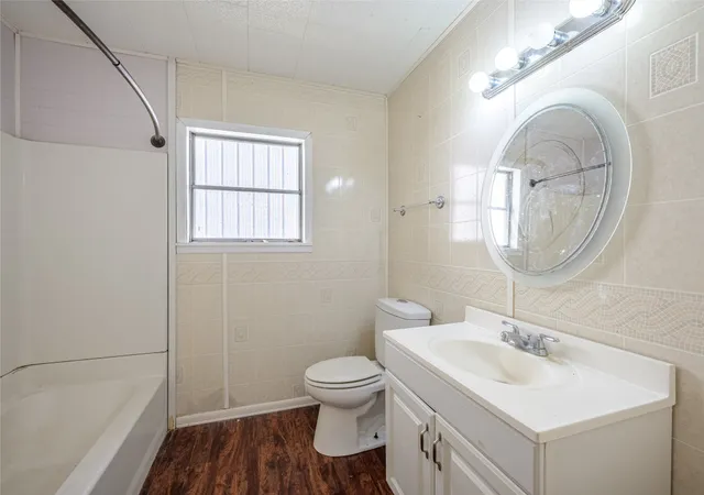 a bathroom with a sink toilet and a mirror
