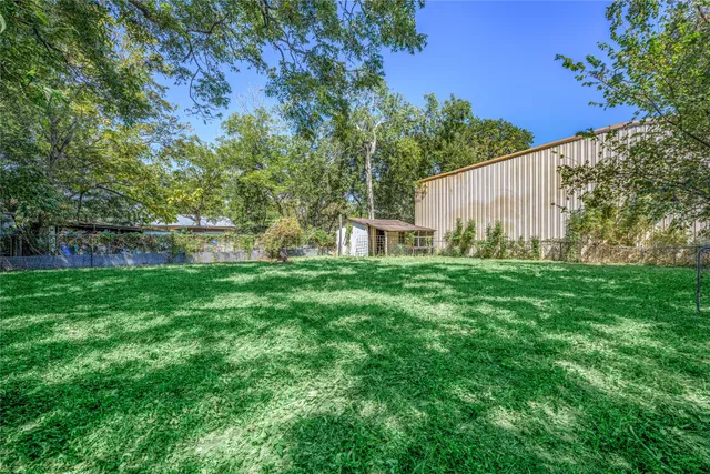 a view of house with backyard