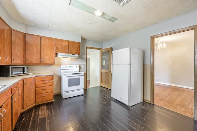 a kitchen with stainless steel appliances a stove a refrigerator and cabinets