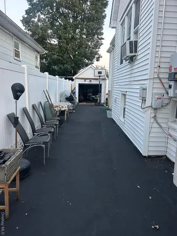 a view of a patio with table and chairs with wooden floor and fence