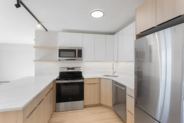a kitchen with a sink stove and refrigerator