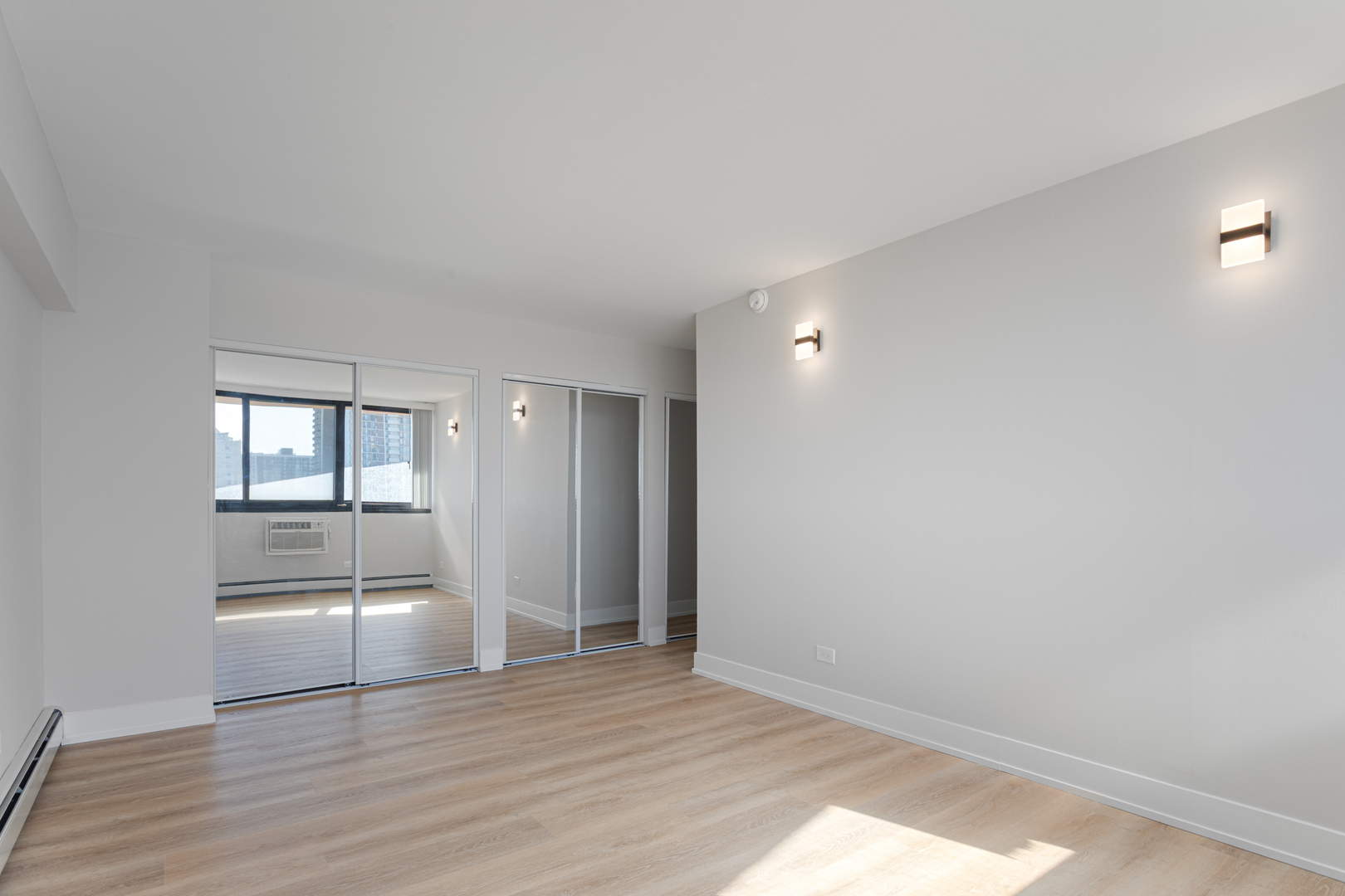 6166 North Sheridan Road, Unit 6K Chicago, IL 60660 - Photo 7 of 21 a view of empty room with wooden floor and kitchen
