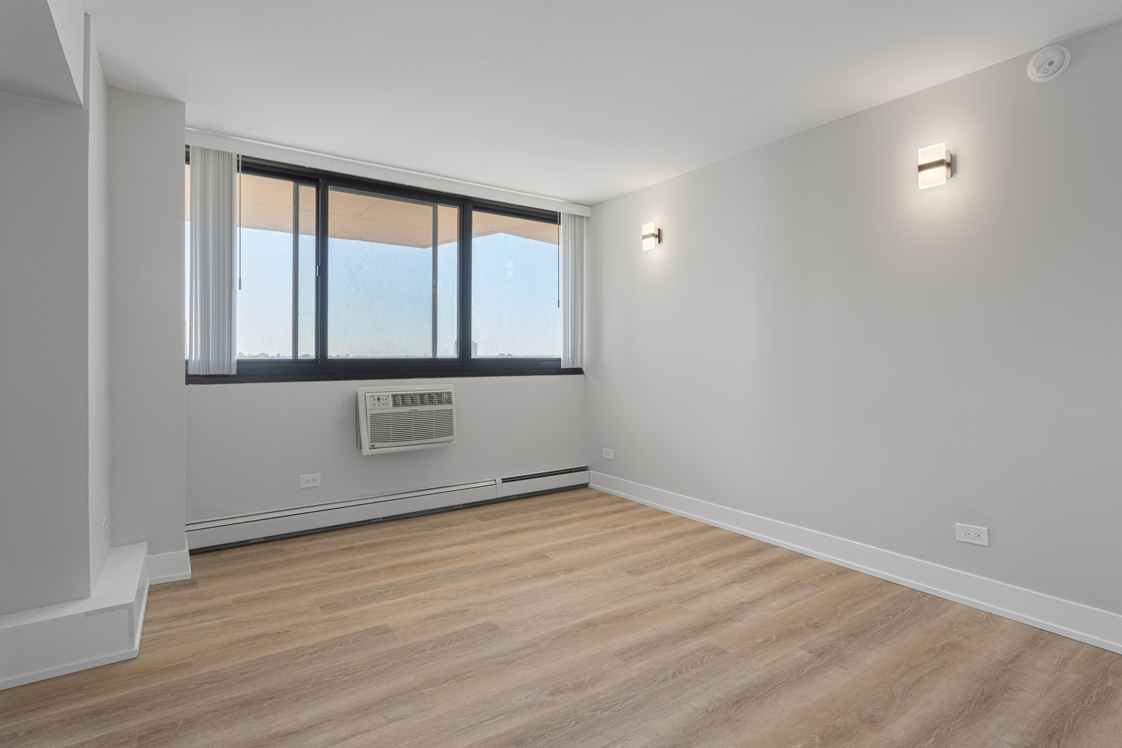 6166 North Sheridan Road, Unit 6K Chicago, IL 60660 - Photo 9 of 21 a view of an empty room with wooden floor and a window