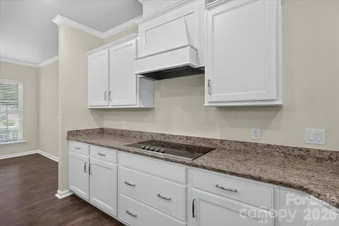 a kitchen with granite countertop kitchen island a sink appliances and a counter space