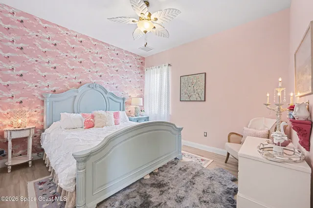 a bedroom with a bed dresser and a window