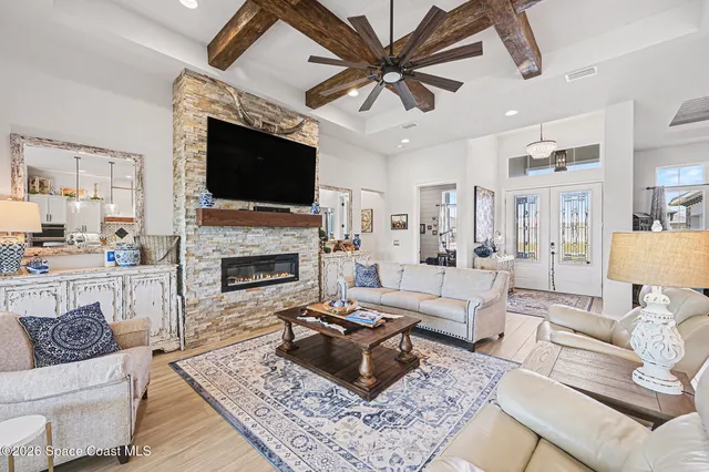 a living room with furniture a flat screen tv and a fireplace
