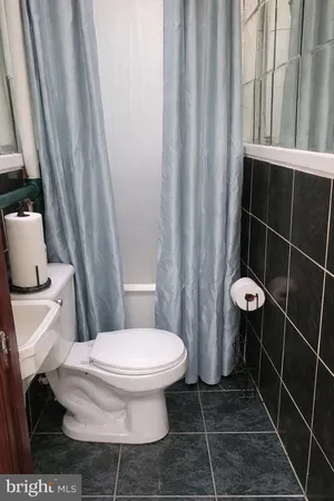 a living room with furniture and potted plant