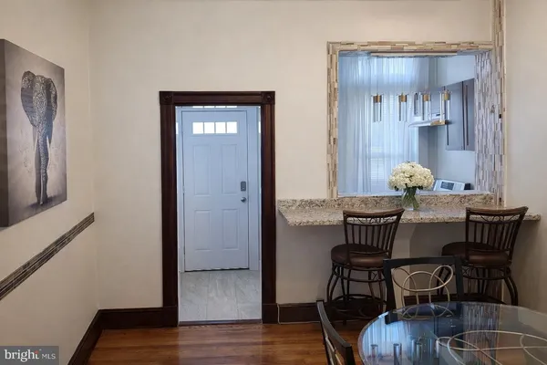 a view of a dining room with furniture and wooden floor