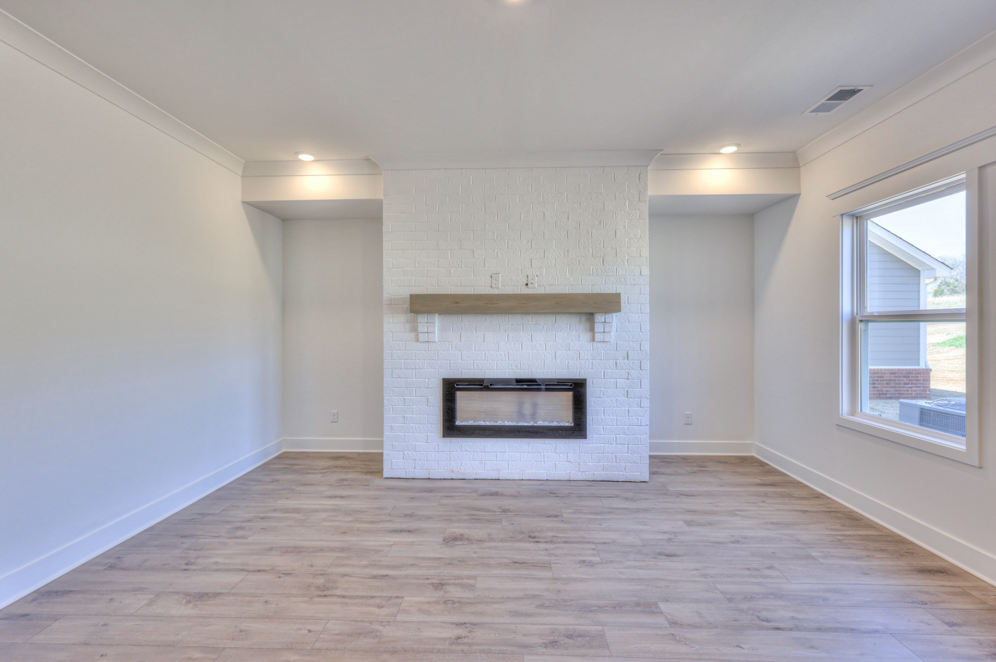 2584 Bluestem Road Columbia, TN 38401 - Photo 22 of 35 a view of an empty room with a fireplace and a window