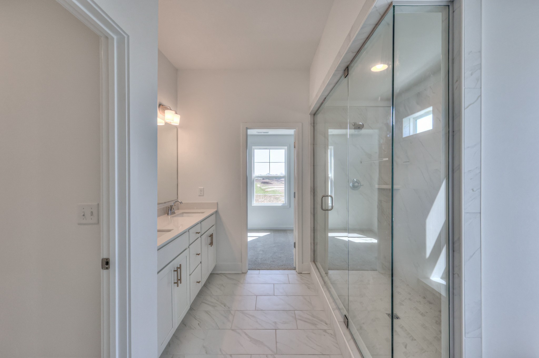 2584 Bluestem Road Columbia, TN 38401 - Photo 26 of 35 a bathroom with a glass door shower a sink and a mirror