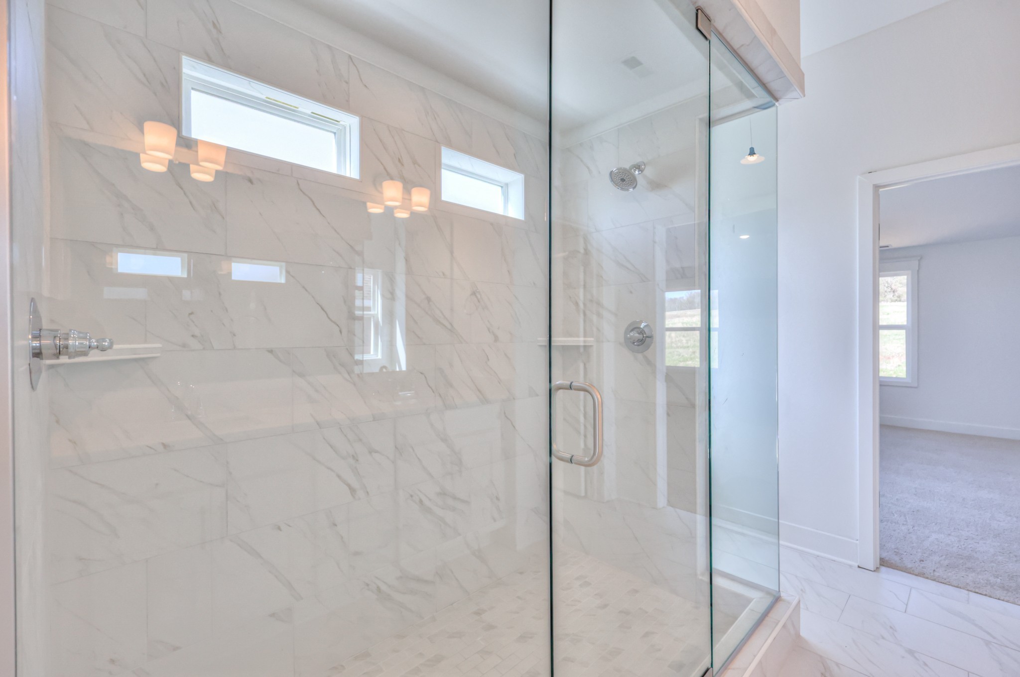 2584 Bluestem Road Columbia, TN 38401 - Photo 30 of 35 a bathroom with a glass shower door and a bathroom