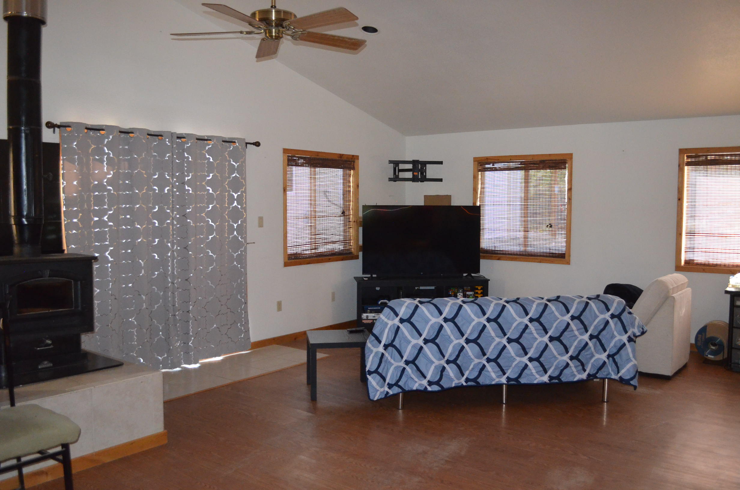132860 Highway 97 Crescent, OR 97733 - Photo 3 of 25 a living room with furniture a flat screen tv and a fireplace