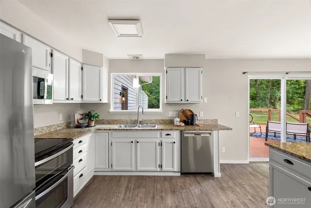 a kitchen with stainless steel appliances granite countertop a stove and a sink