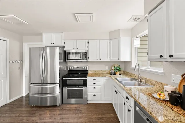 a kitchen with stainless steel appliances a refrigerator sink and stove