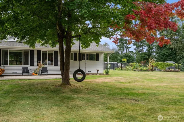 a view of a house with backyard and porch