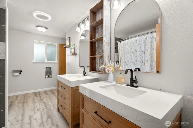 a bathroom with a sink a toilet and a mirror