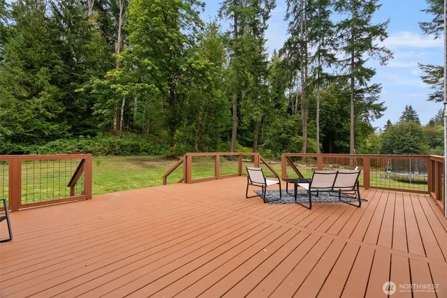 a backyard of a house with wooden floor chairs and wooden floor