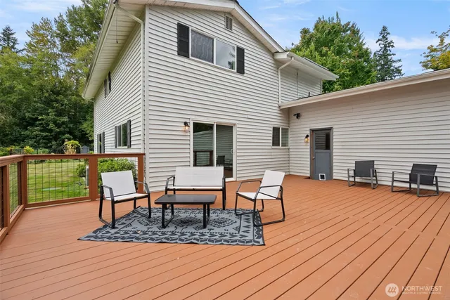 a view of a house with a yard and sitting area