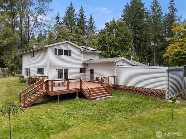 a view of a house with backyard space and sitting area