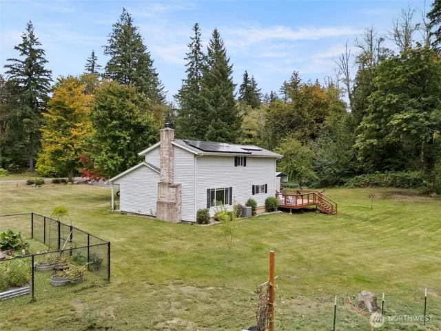 a view of a yard with swimming pool and sitting area