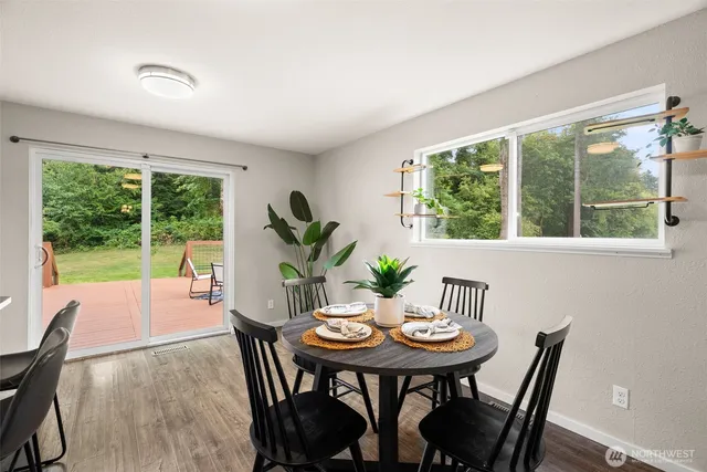 a view of a dining room with furniture window and outside view