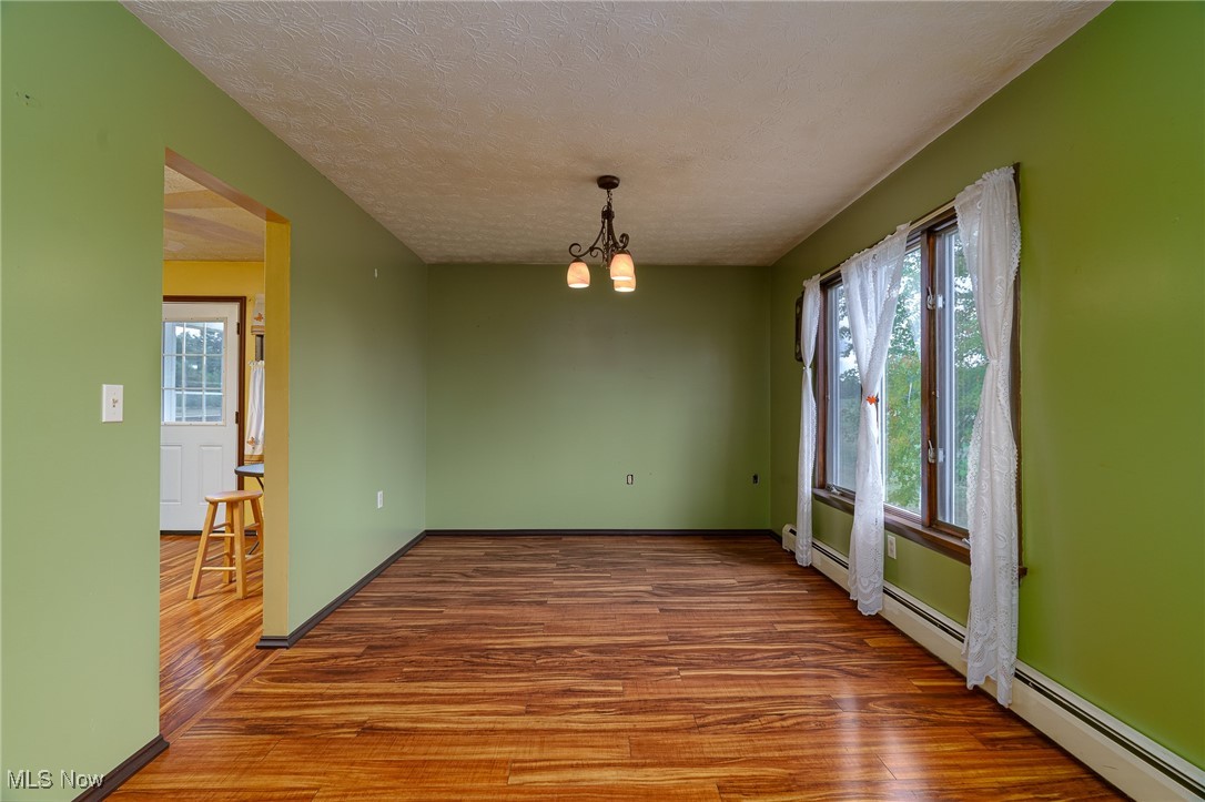 6747 Giddings Road Rootstown, OH 44272 - Photo 7 of 39 Dining room featuring a chandelier, large picture window and entrance to kitchen