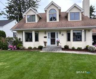 20 Norman Road Stamford, CT 06906 - Photo 30 of 35 a front view of a house with a yard and garage