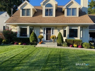 20 Norman Road Stamford, CT 06906 - Photo 31 of 35 a front view of a house with a yard and potted plants