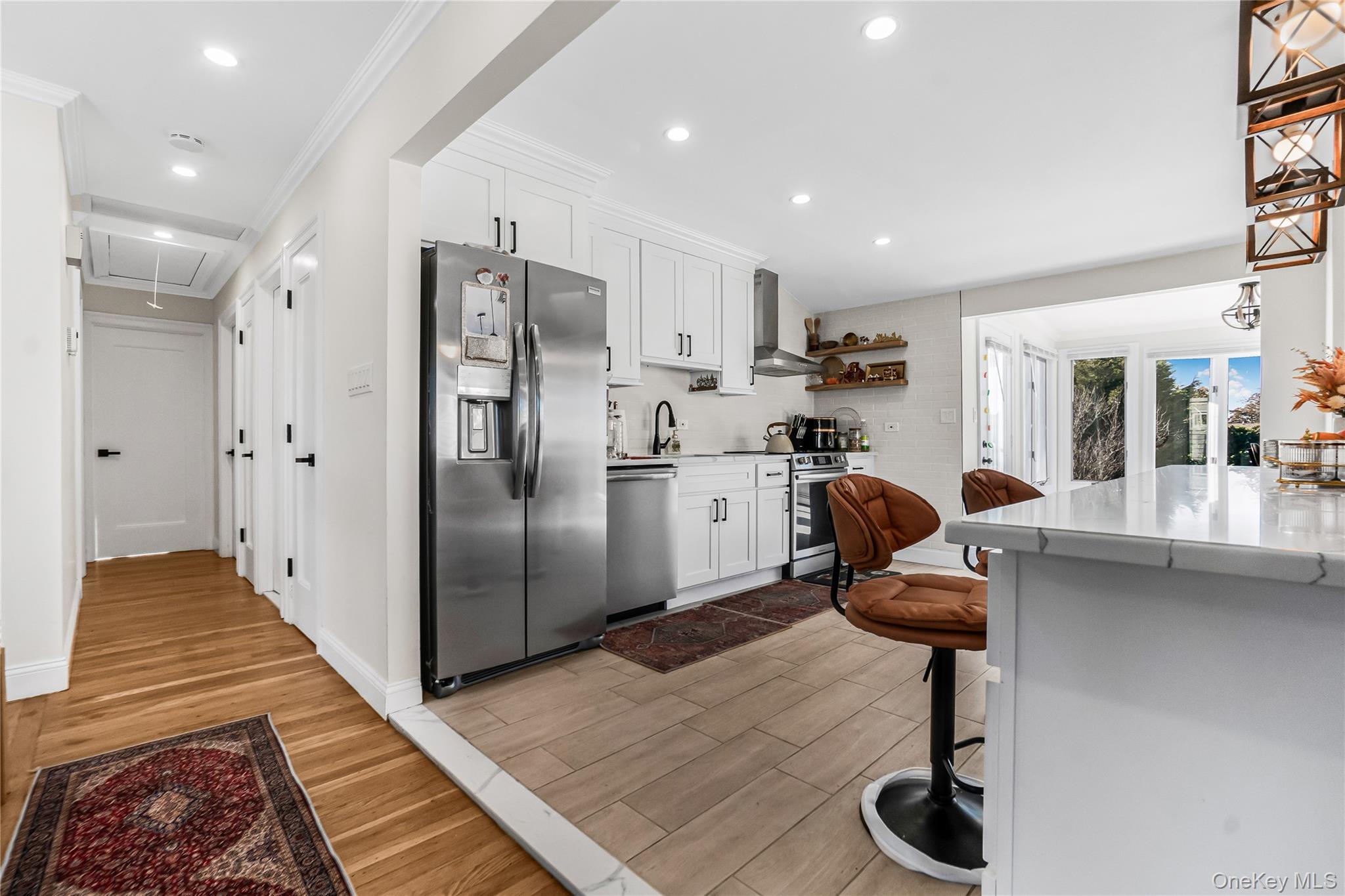 107 Beverly Road Massapequa, NY 11758 - Photo 12 of 30 a kitchen with stainless steel appliances granite countertop a sink refrigerator and cabinets