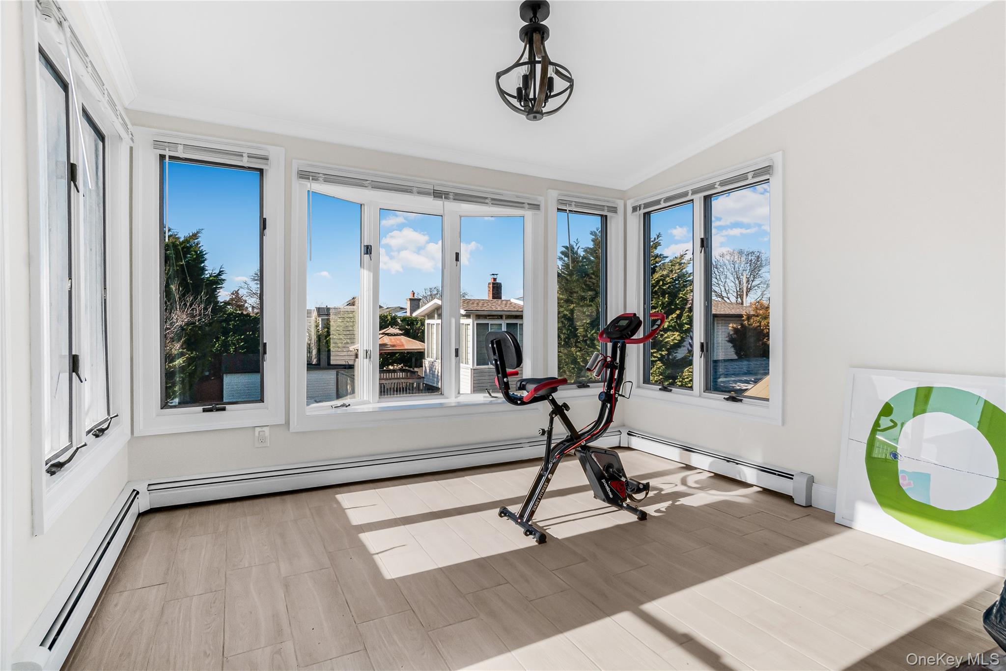 107 Beverly Road Massapequa, NY 11758 - Photo 14 of 30 a view of a room with gym equipment and windows