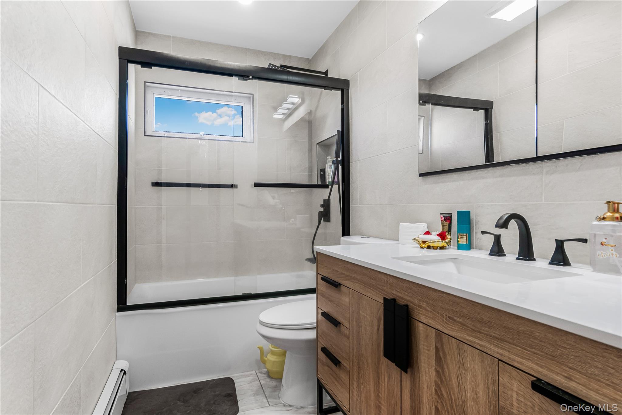 107 Beverly Road Massapequa, NY 11758 - Photo 17 of 30 a bathroom with a sink a toilet and mirror