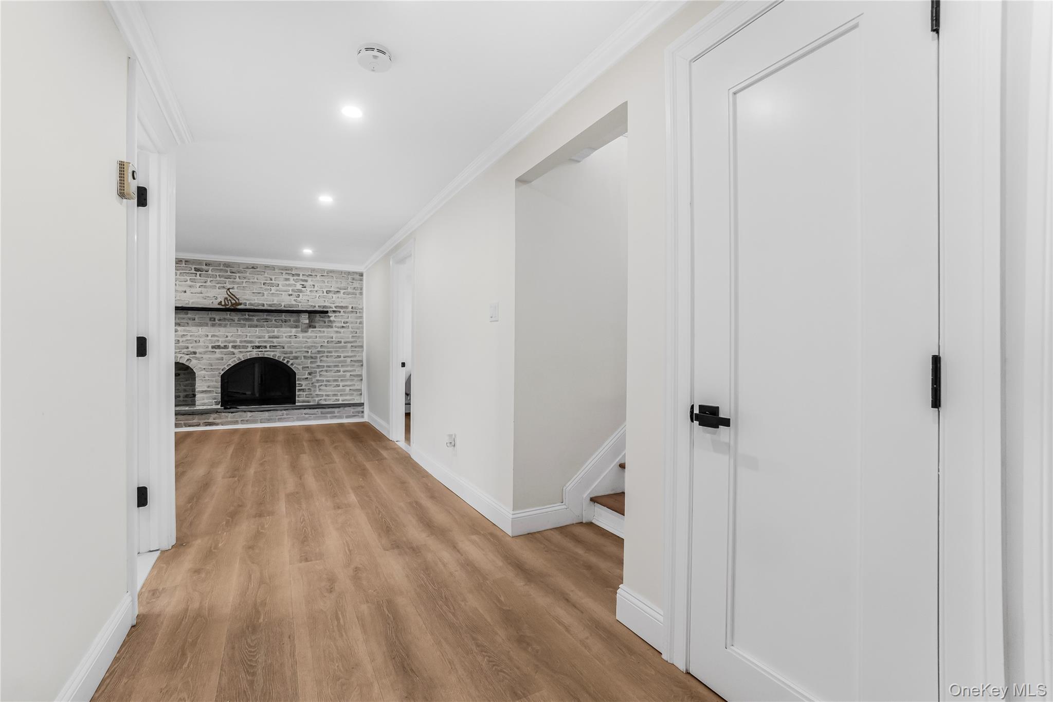 107 Beverly Road Massapequa, NY 11758 - Photo 25 of 30 a view of livingroom with fireplace wooden floor and window