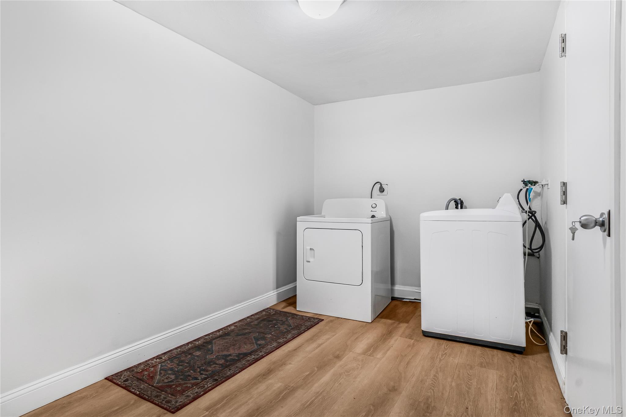 107 Beverly Road Massapequa, NY 11758 - Photo 5 of 30 a view of a storage & utility room with a washer dryer