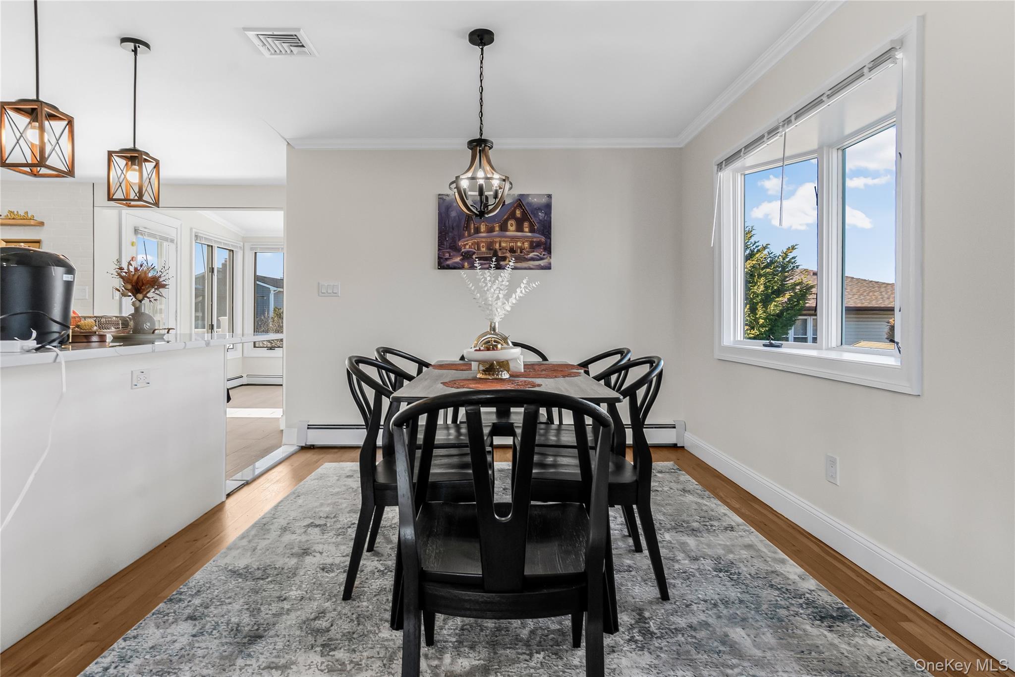 107 Beverly Road Massapequa, NY 11758 - Photo 9 of 30 a view of a dining room with furniture window and wooden floor