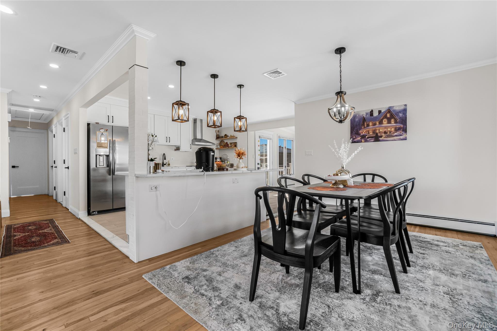107 Beverly Road Massapequa, NY 11758 - Photo 10 of 30 a view of a dining room with furniture and wooden floor