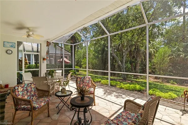 a patio with yard glass top table and chairs