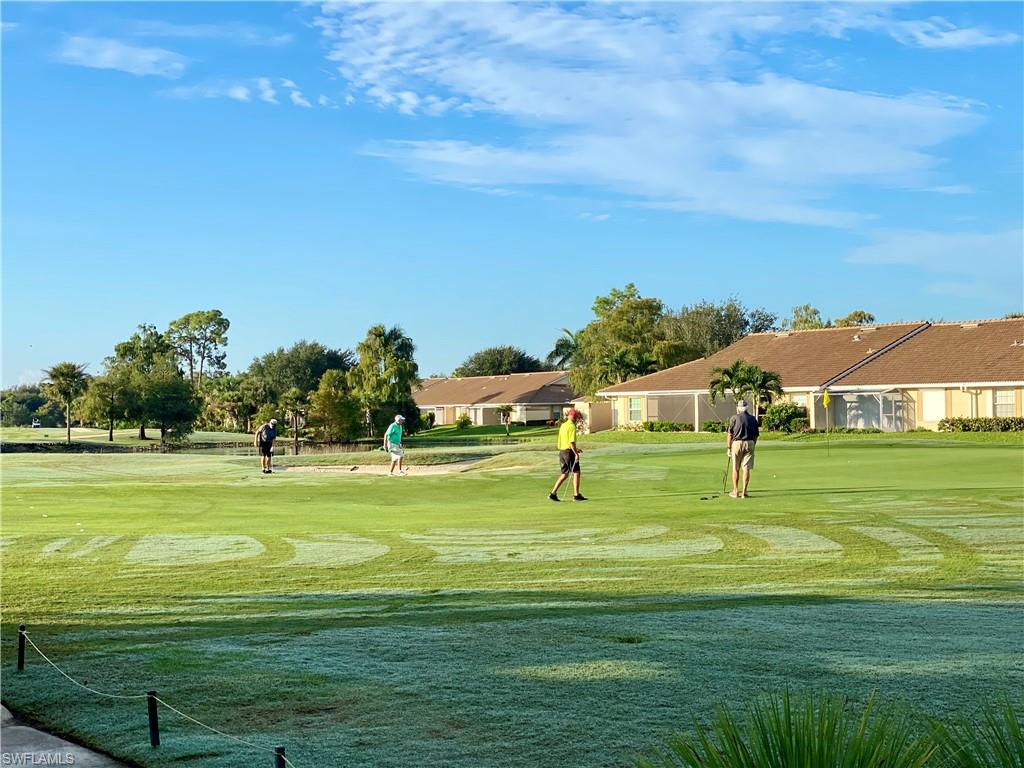 1409 Athol Way, Unit 101 Naples, FL 34104 - Photo 32 of 37 Surrounding community featuring view of golf course, a lawn, and a residential view
