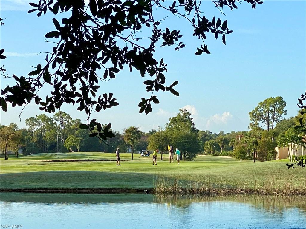 1409 Athol Way, Unit 101 Naples, FL 34104 - Photo 33 of 37 View of property's community featuring view of golf course, a yard, and view of scattered trees