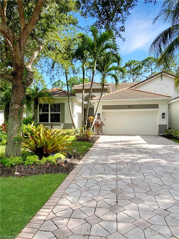 1409 Athol Way, Unit 101 Naples, FL 34104 - Photo 36 of 37 Single story home featuring decorative driveway, an attached garage, stucco siding, and a tiled roof