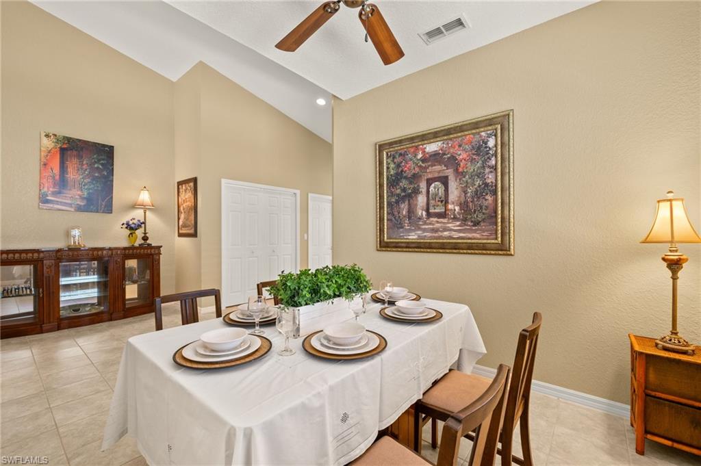 1409 Athol Way, Unit 101 Naples, FL 34104 - Photo 5 of 37 Dining room featuring high vaulted ceiling, a ceiling fan, baseboards, light tile patterned floors, and visible vents