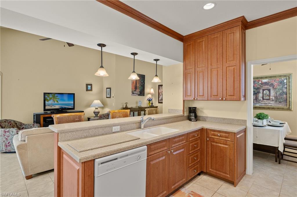 1409 Athol Way, Unit 101 Naples, FL 34104 - Photo 37 of 37 Kitchen with white dishwasher, a sink, light tile patterned flooring, and open floor plan