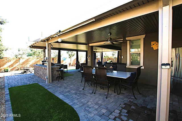 a view of a house with backyard and sitting area