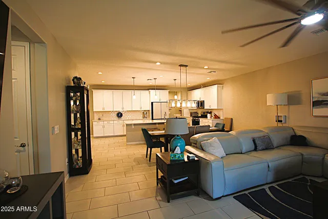 a kitchen with refrigerator and chairs