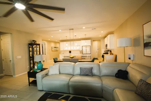 a kitchen with stainless steel appliances kitchen island granite countertop a sink a stove and a refrigerator