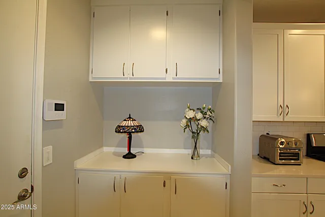 a living room with furniture a chandelier and a window