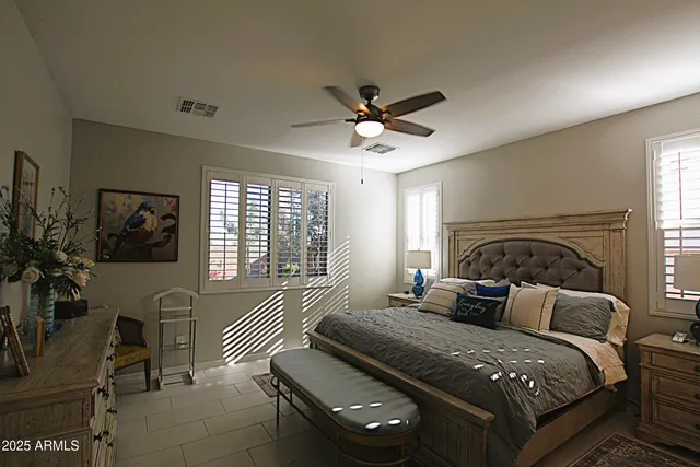 a bedroom with a bed and a chandelier